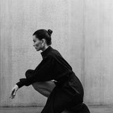 Woman in black MAY dress with artisanal hand-embroidered details, premium cotton voile, minimalist luxury fashion by Aymone Studio