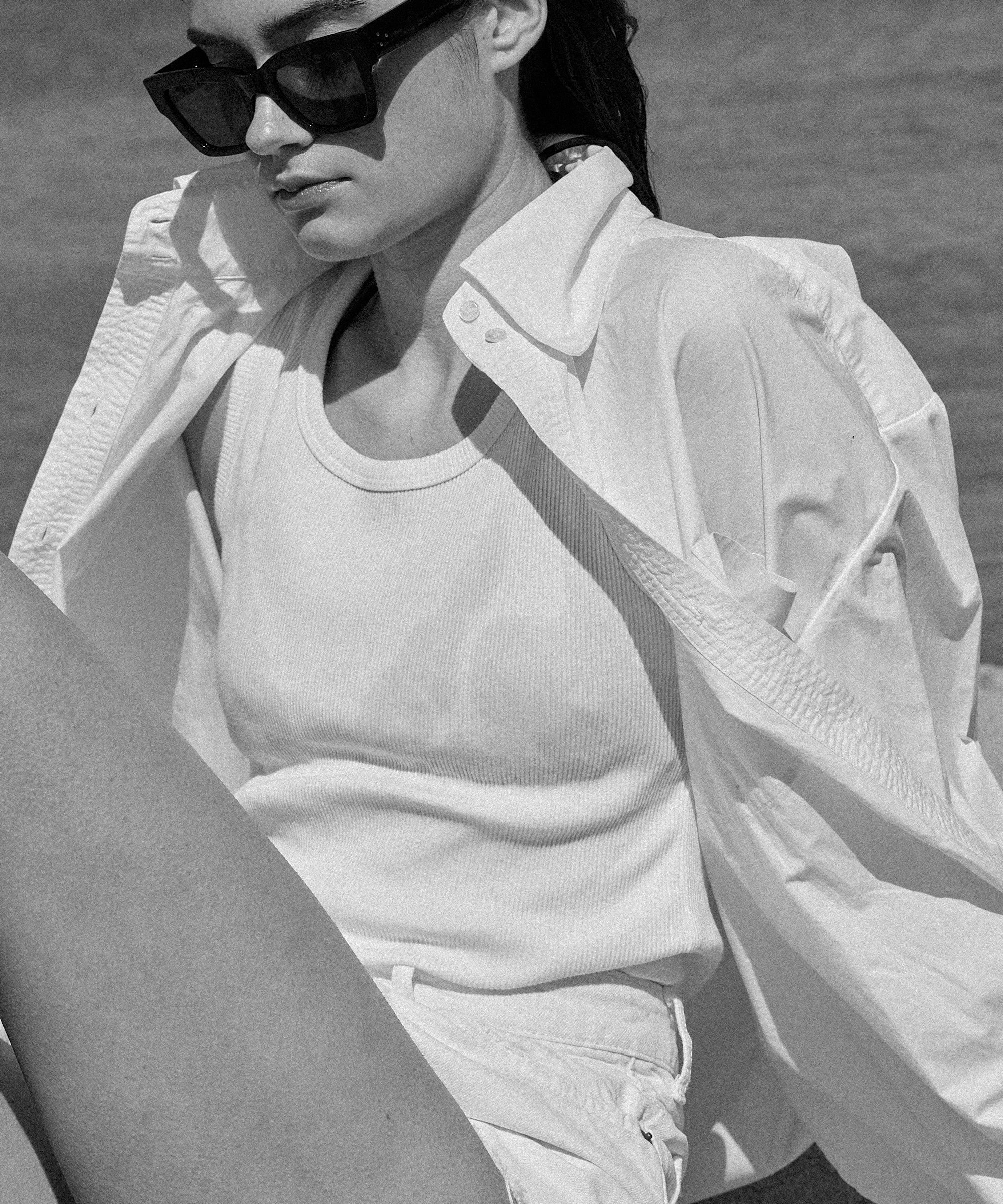 Woman wearing Aymone Studio ELE white cotton poplin shirt with hand-embroidered details and voluminous oversized cut