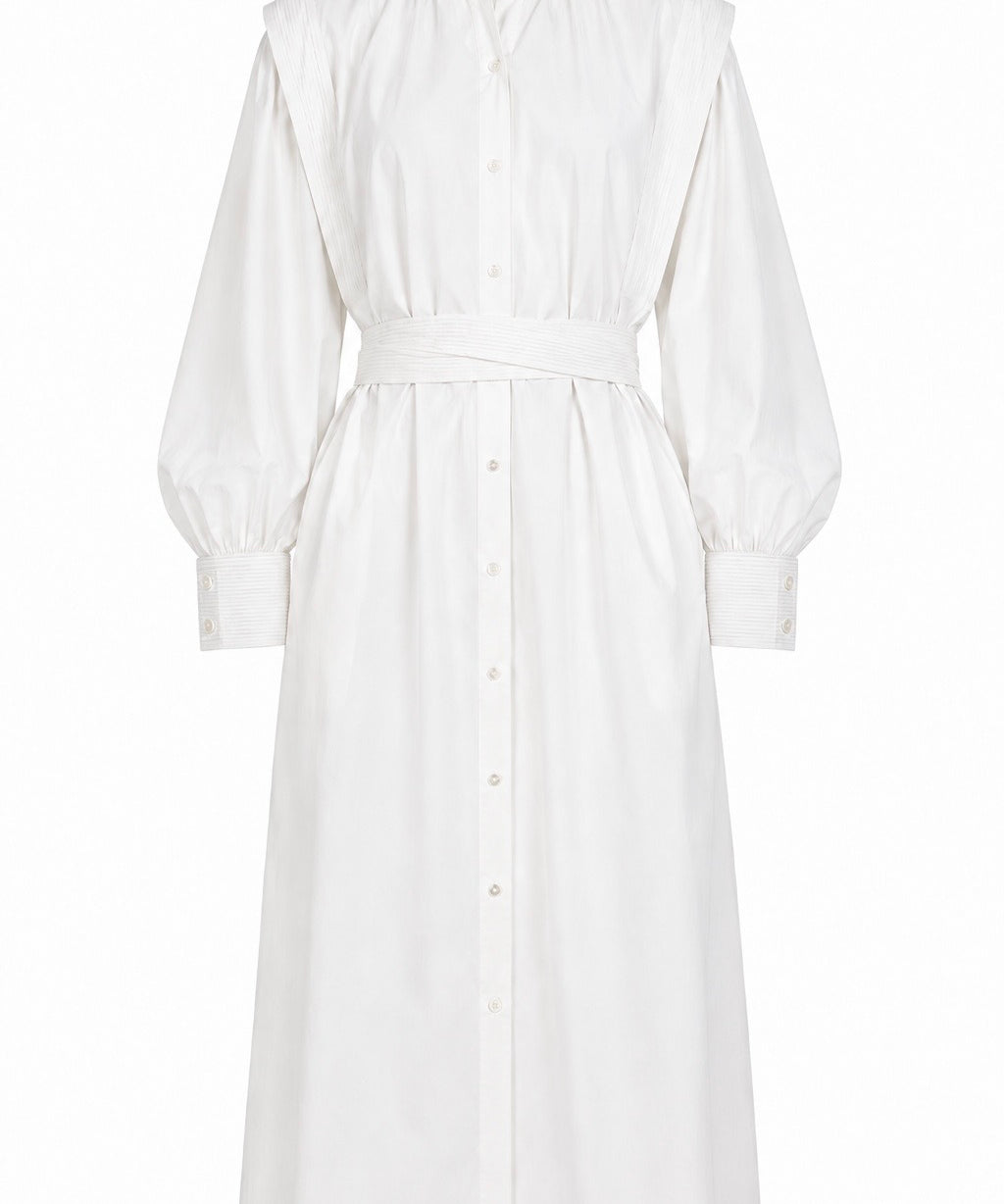 White May dress by Aymone Studio featuring voluminous sleeves, high collar, handcrafted piping, and full-length button placket, embodying refined minimalist luxury