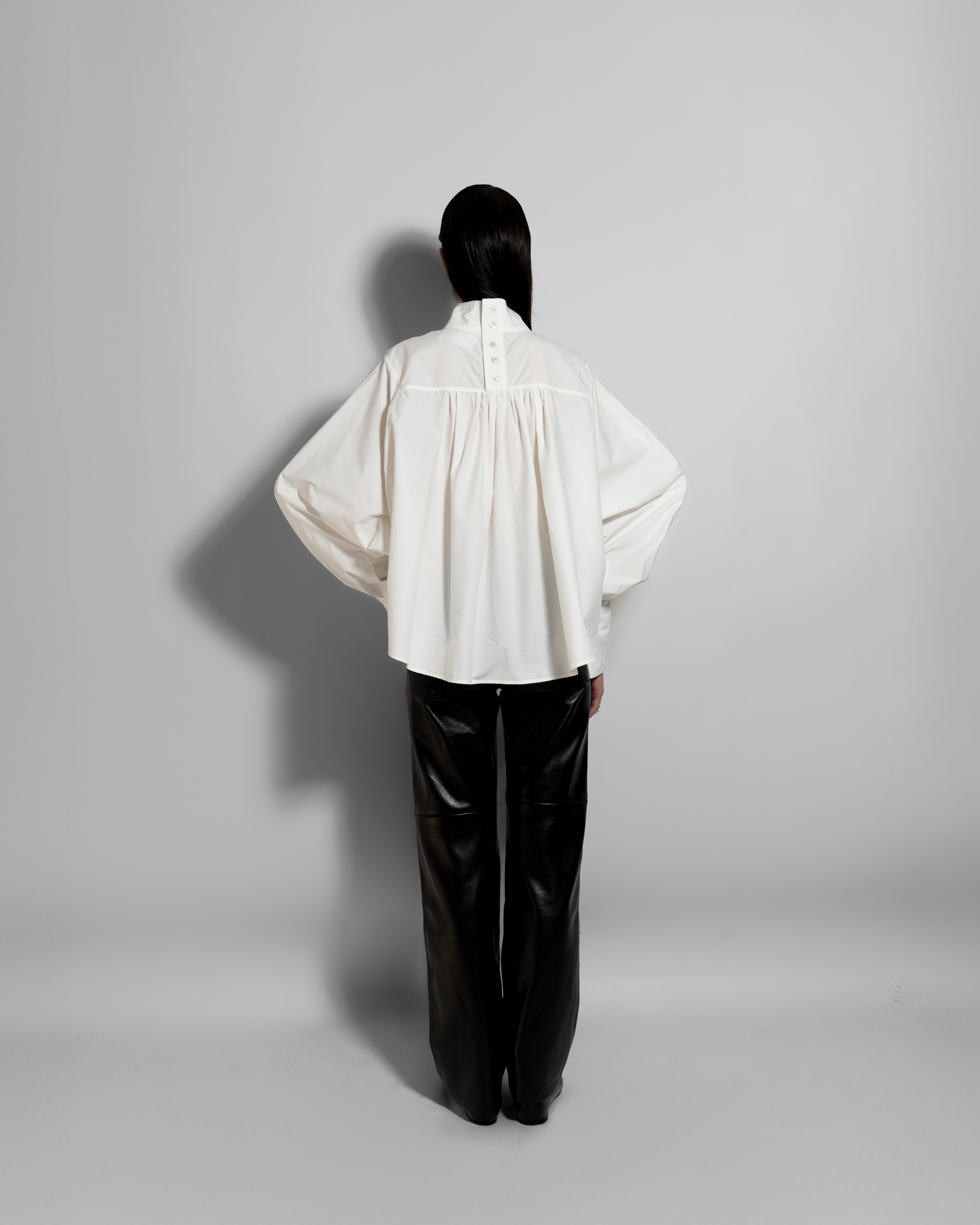 women oversized shirt back view fluid silhouette modern minimal style