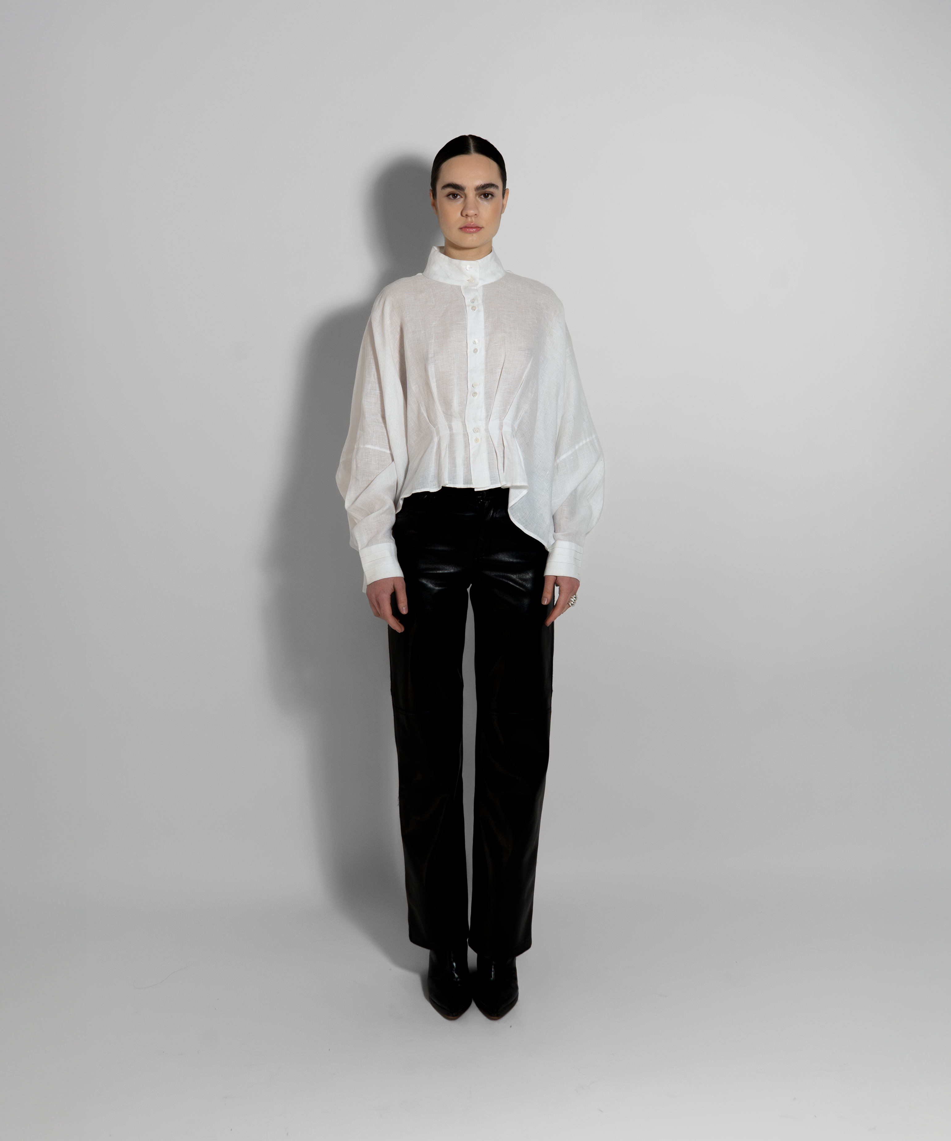 White linen shirt with high neckline and tailored black pants full look