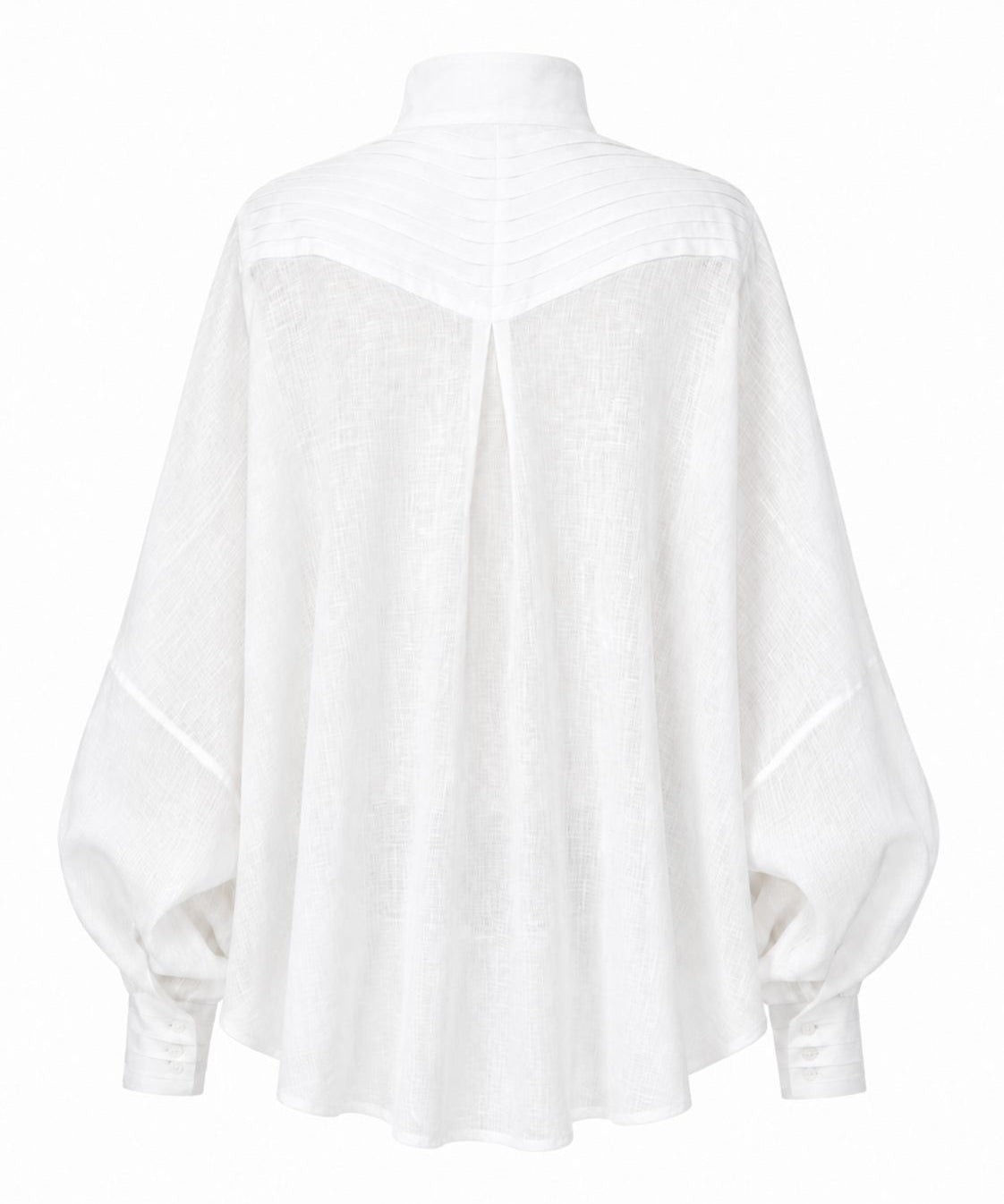 Cate shirt in soft white linen with sculptural pleats, generous silhouette, and handmade cuff details by Aymone Studio
