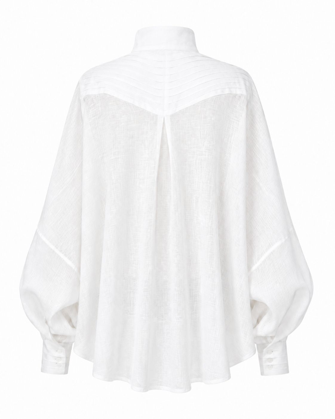 Cate shirt in soft white linen with sculptural pleats, generous silhouette, and handmade cuff details by Aymone Studio