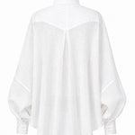 Cate shirt in soft white linen with sculptural pleats, generous silhouette, and handmade cuff details by Aymone Studio
