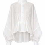Cate white linen shirt with sculptural pleats, structured collar, and fluid oversized silhouette by Aymone Studio